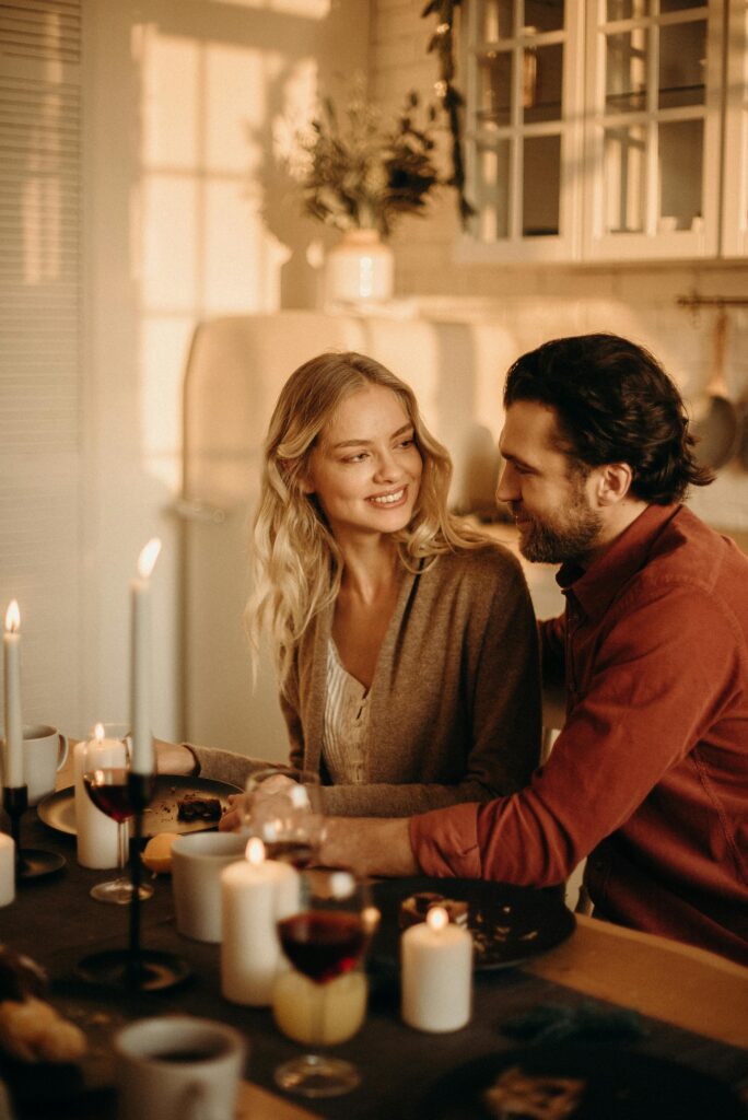 A serene romantic dinner setting with a couple enjoying candlelight, wine, and happiness.